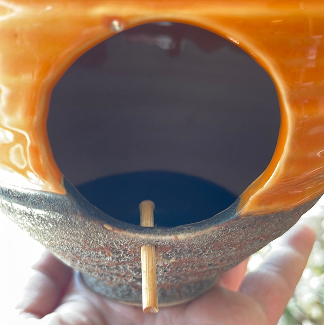Orange ceramic bird house