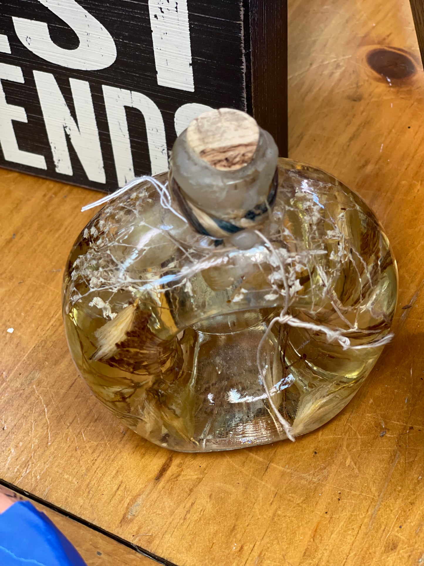 Dried flowers in massage oil in jar