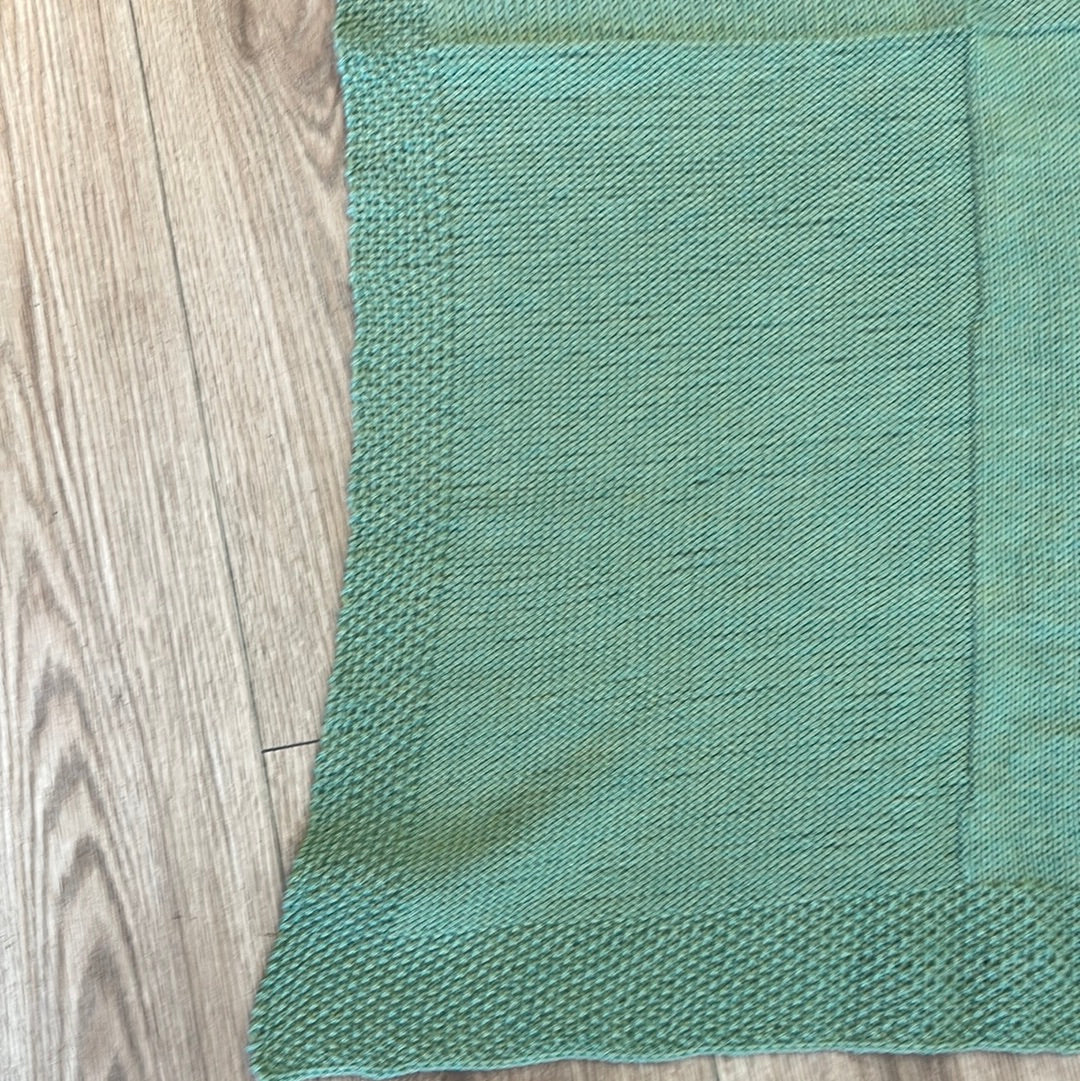 Green handmade knitted baby crib blanket