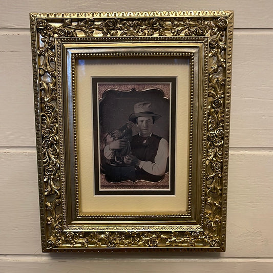 B/w guy with a chicken in Gold colored resin frame.