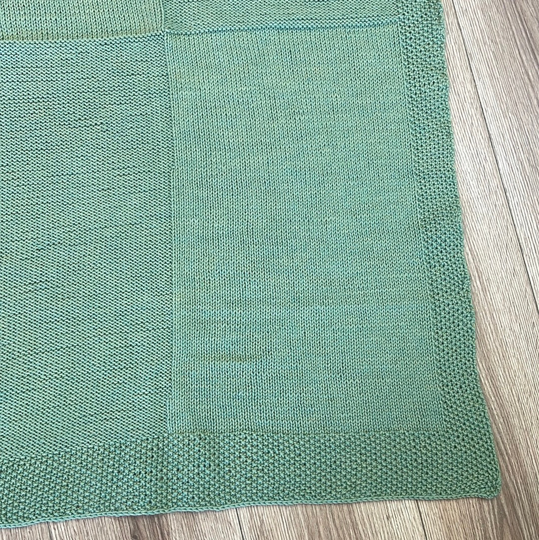Green handmade knitted baby crib blanket