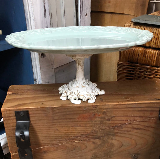 Light blue ceramic platter on a distressed white pedestal