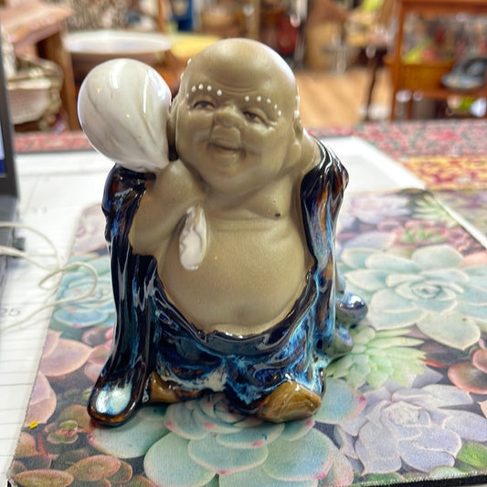 Ceramic Buddha with blue robe and white sack