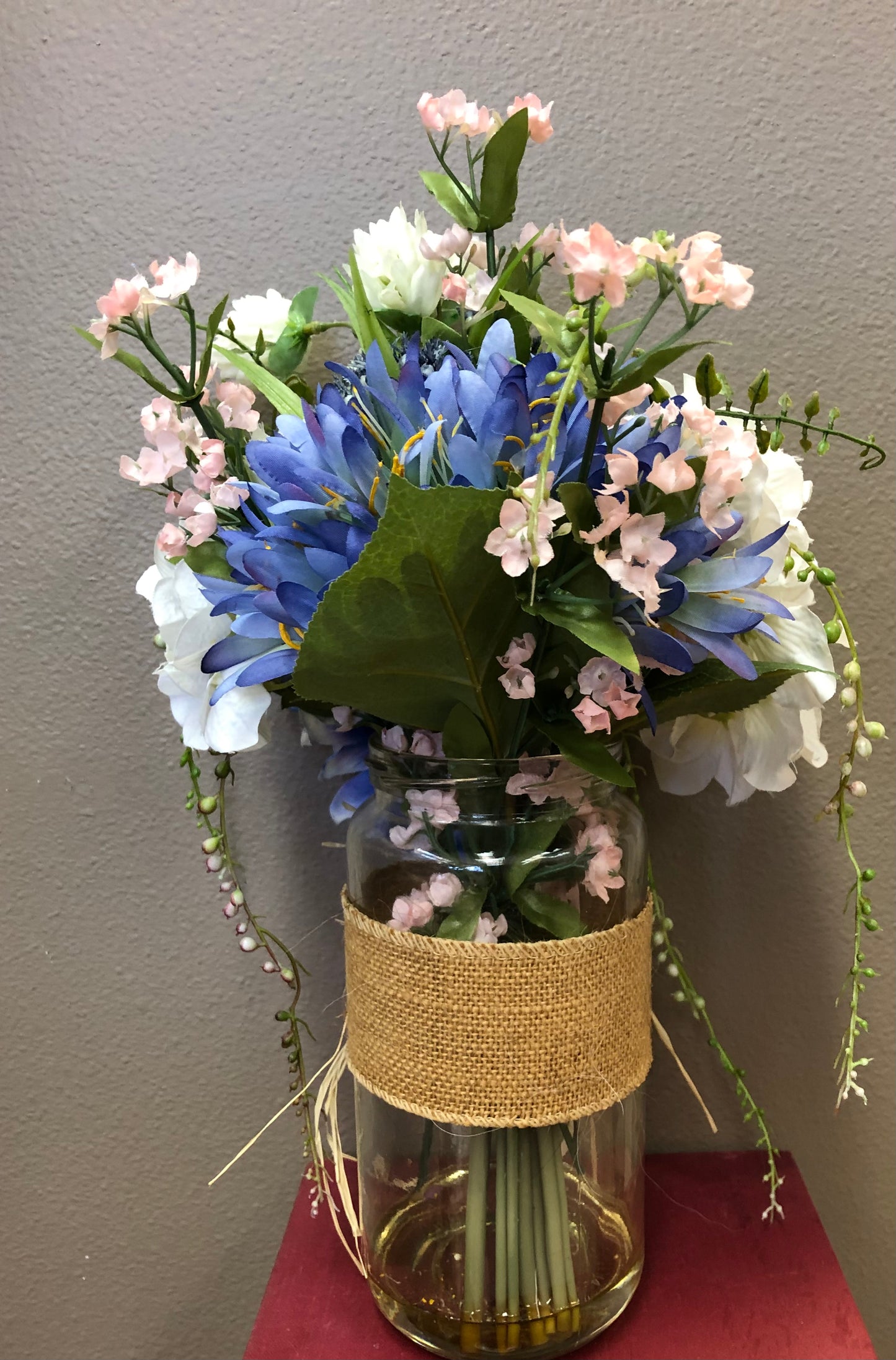 Faux spring bouquet in glass vase