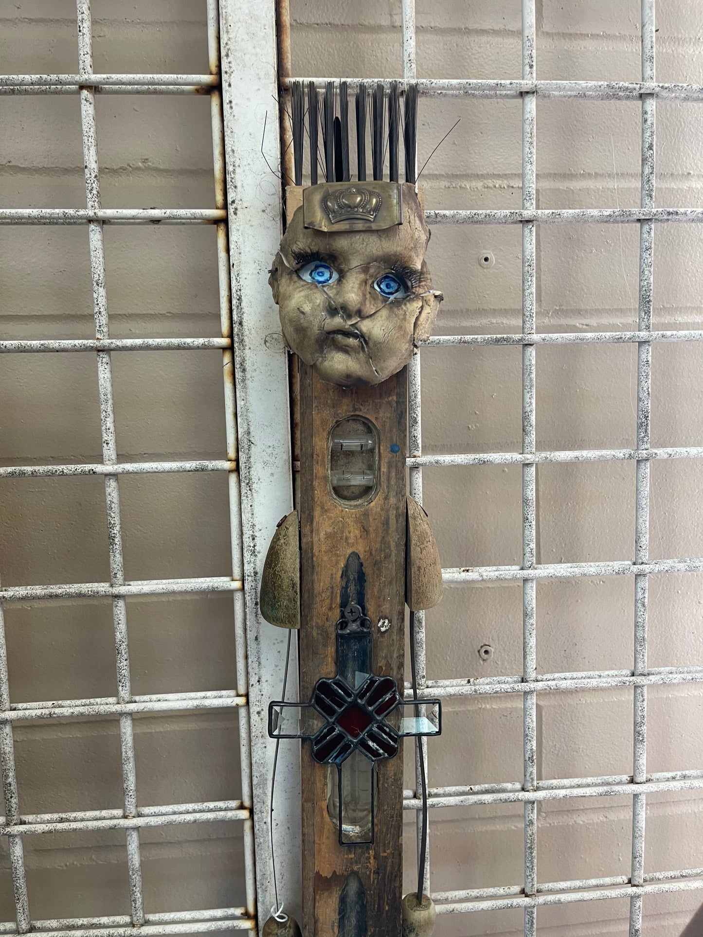 Found Art sculpture - doll head on level with fish feet