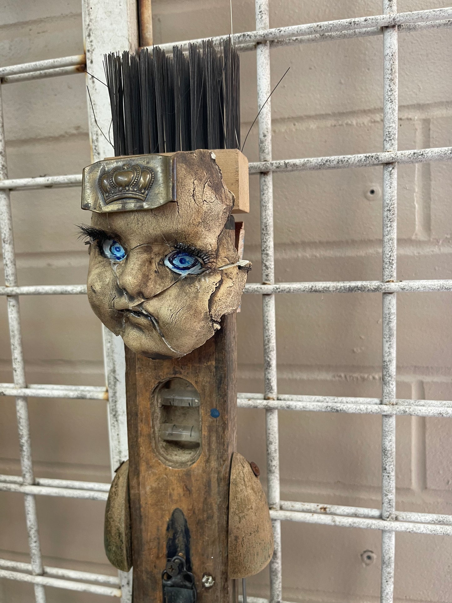 Found Art sculpture - doll head on level with fish feet